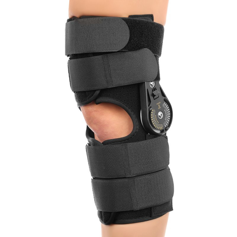 Orteza kolana z regulowanym zaciskiem i paskami mocującymi, zapewniająca stabilizację i wsparcie stawu kolanowego.