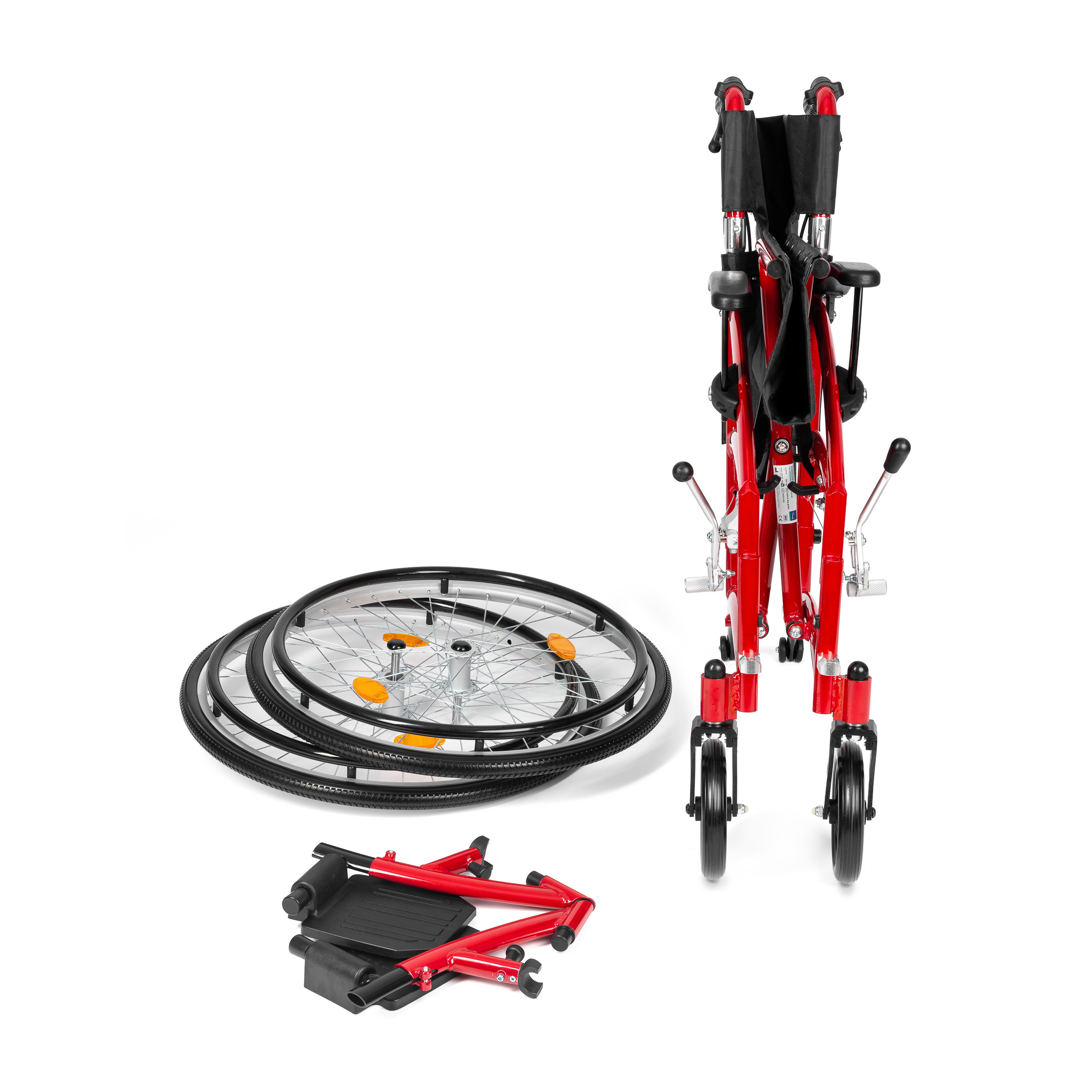 Składany wózek inwalidzki w kolorze czerwonym, rozłożony, z odczepionymi kołami i podnóżkami, na białym tle.