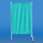 Przyłbica z niebieską zasłoną na metalowej ramie na kółkach, służy do zapewnienia prywatności lub ochrony.