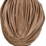 Beżowa czapka z miękkiego, plisowanego materiału, ułożona na białej podstawie.