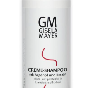 Biały butelka szamponu GM Gisela Mayer z czarnym i czerwonym napisem, zawiera krem-shampoo z arganem i keratyną.