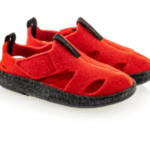 Czerwone, miękkie kapcie z czarną podeszwą i elastycznymi paskami na palce.